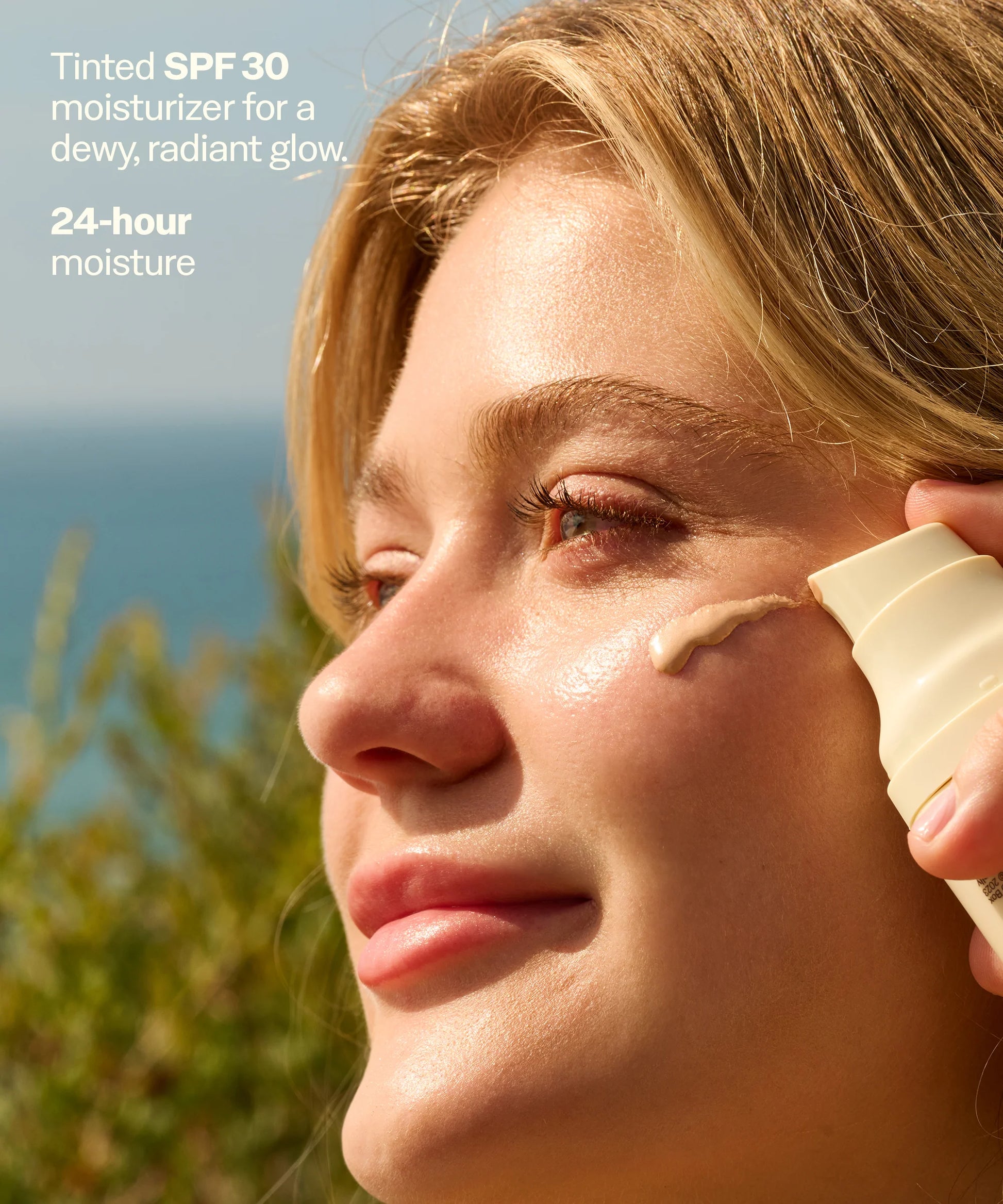 Glow SPF 30 sunscreen face lotion by Sun Bum — in-hand view